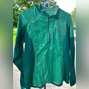 The North Face teal windbreaker.